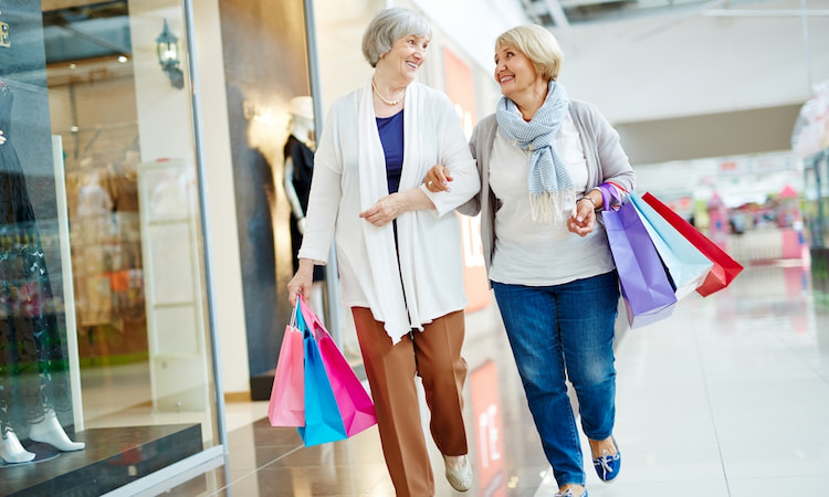 a senior couple walks through a mall in Denver